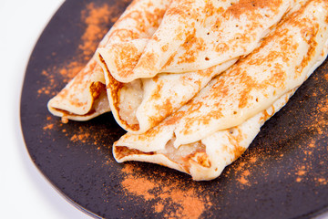 Pancakes stuffed with braised apples sprinkled with cinnamon