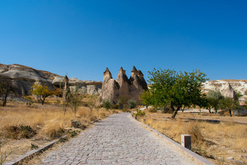 low angle view of stone road and rock formations in goreme open air museum, popular and famous place in cappadocia, turkey
