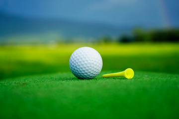 Golf ball on green in beautiful golf course at sunset background.