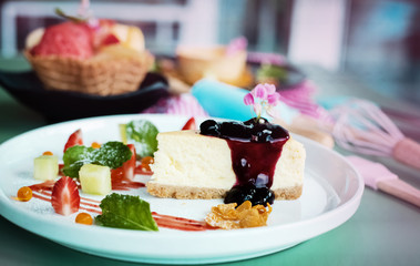 The dish of blueberry cheese cake put on table,blurry light around