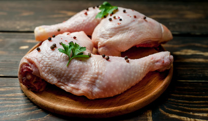 chicken legs on wooden background