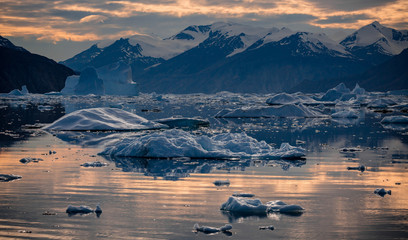 sunset at the arctic landscape, with icebergs photographed Greenland in Scoresby Sound fjords
