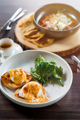 Lunch Time at Cafe. Sandwich with poahed egg on table isolated close-up top view