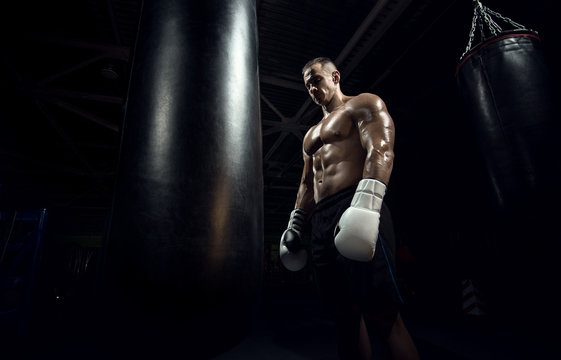 boxer in gym with punching bag