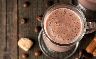 Chocolate, coffee, milk, banana shake on wooden background. Smoothie with cookies. Milkshake. Protein diet. Healthy food concept.