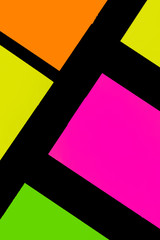 Green, yellow, orange and purple hue colorful office stickers on black paper. Office noteparer as...