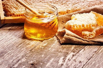 Sweet honey in the comb, glass jar.