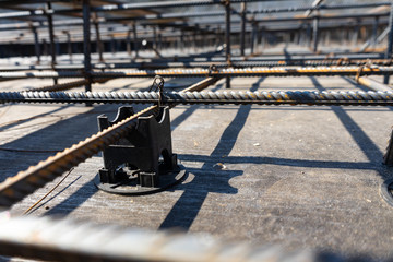 Tie rebar beam cage on construction site. Steel reinforcing bar for reinforced concrete.