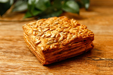 Healthy homemade pastry with integral flour and sunflower seeds. Wooden table and rustic vintage background. Close-up.