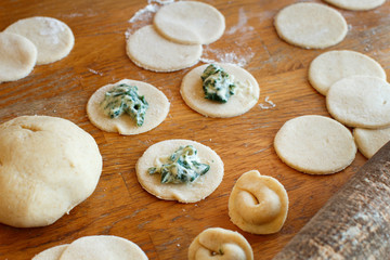 Fototapeta na wymiar Making ravioli with ricotta cheese and spinach