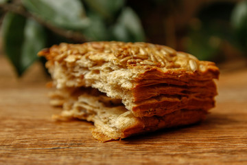 Healthy homemade pastry with integral flour and sunflower seeds. Wooden table and rustic vintage background. Close-up.