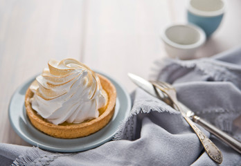 Lemon cream cake, vintage spoon and fork. Сopy space