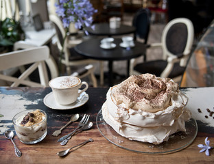 Vintage cafe, on the old steel meringue cake with berries, dessert, a cup of tea