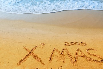 Happy new year concept, 2019 Xmas handwriting on sand beach.