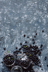   Juicy fresh blueberries on gray concrete background. Picked bilberries in bowl close up. Place for text. Top view 