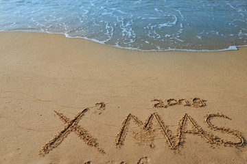 e,Happy new year concept, 2019 Xmas handwriting on sand beach.