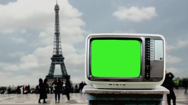 Old TV With Green Screen And the Eiffel Tower, In Paris. You can replace green screen with the footage or picture you want with “Keying” effect in AE  (check out tutorials on YouTube).