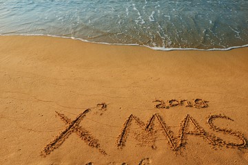 Happy new year concept, 2019 Xmas handwriting on sand beach.