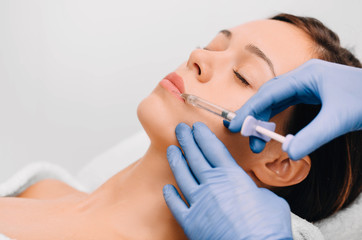 woman having lip injection for lip augmentation
