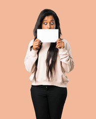 Young afro american woman holding a placard for insert a concept on isolated brown background