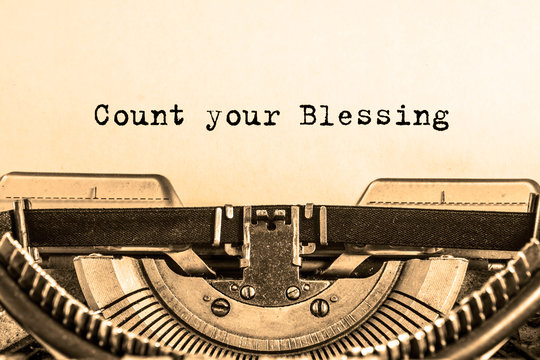 Count your Blessing printed on a piece of paper on a vintage typewriter. writer, essay, journalism.