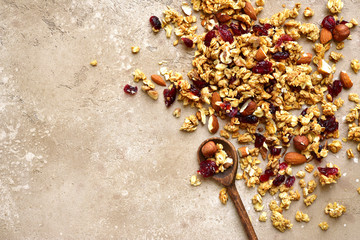 Homemade multicereal granola scattered on a slate table.Top view with copy space. - obrazy, fototapety, plakaty