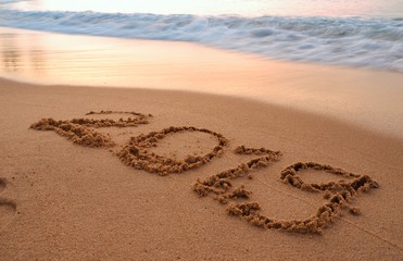 Happy new year concept, 2019 handwriting on sand beach.