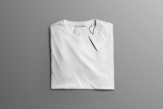 Studio mockup  of clothe with  neatly folded blank T-shirt  on the gray background.