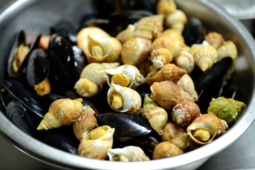different clams in a metal bowl
