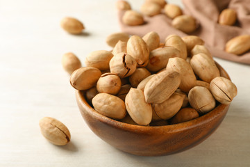 Ripe pecan nuts in dish served on table, closeup