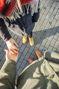 First person view of couple holding hands. Loving couple holding hands while walking at sunset. love confession concept