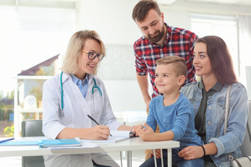 Little boy with parents visiting children's doctor in hospital