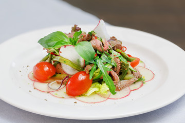 Salad with fresh vegetables in a white plate