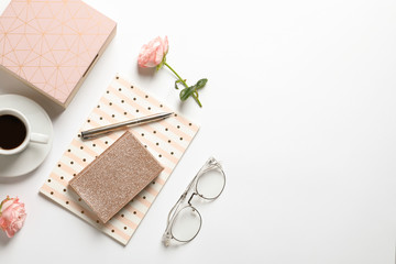 Flat lay composition with notebooks, cup of coffee and stationery on white background. Space for...