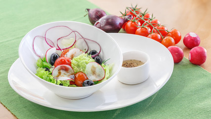 Salad with fresh vegetables in a white plate