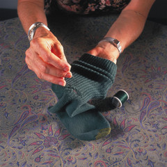 woman darning sock