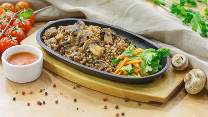 Buckwheat with mushrooms in a pan