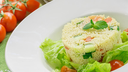 Salad with fresh vegetables in a white plate