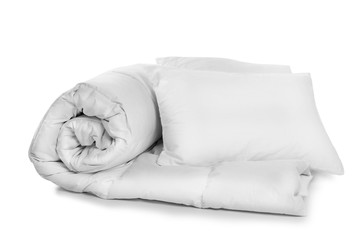Clean blanket and pillows on white background