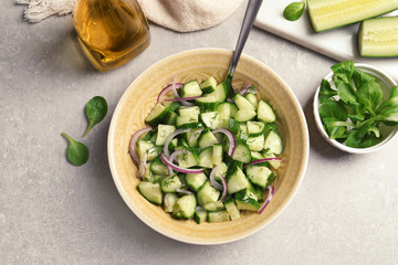 Plate with tasty cucumber salad served on table, top view