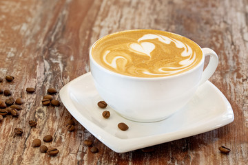 Coffee with milk, latte, cappuccino in a cup on a wooden background