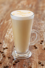 Coffee with milk, latte, cappuccino in a cup on a wooden background