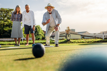 Group of senior people playing boules in a lawn