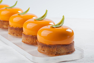 Bowl-shaped sweet cakes on white wooden table