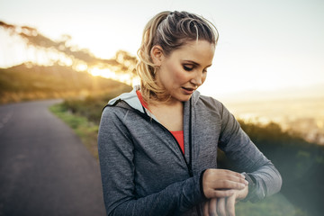 Fitness woman looking at her wrist watch