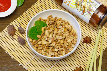 Vegetable salad in a plate on a wooden background, top view