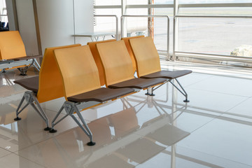 Color rows chair with glass window at terminal gate