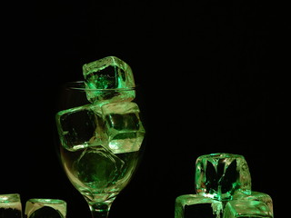 Dark and Dirty Ice Cubes in a Wine Glass, Depicting Square Shaped Germ Infested Frozen Water.