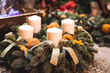 A christmas wreath with four candles and tapes is a symbol of advent, favorite winter holiday. Green brunches is a base of decoration.