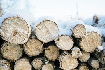 Firewood laying outdoors in the winter country house in the snow 